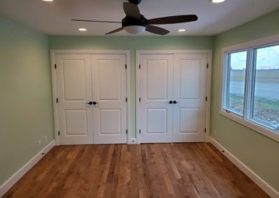Bedroom with green wall and 2 white doors